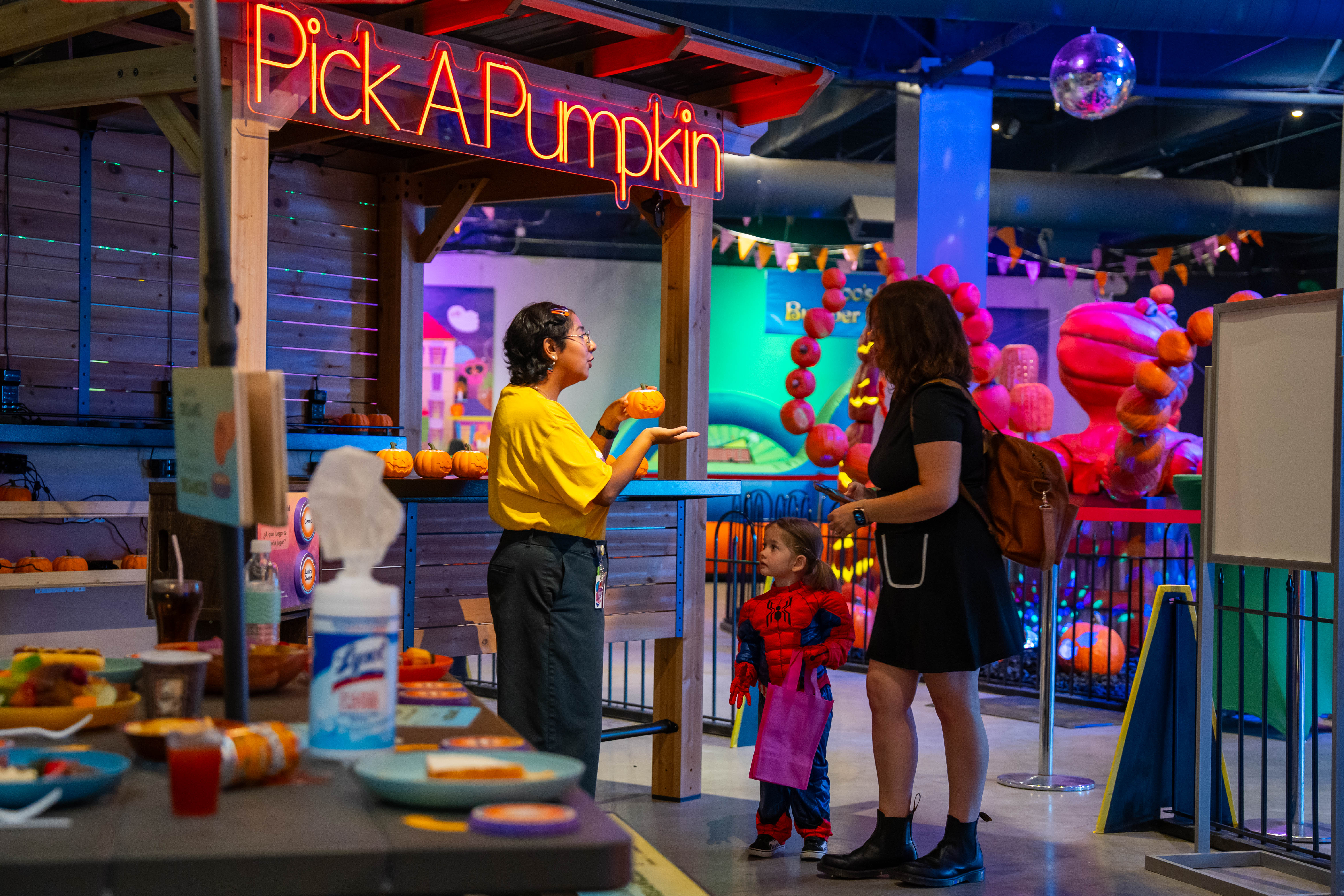 family with pumpkin at educational exhibit