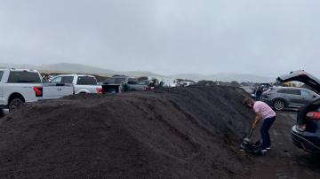 Resident shoveling compost