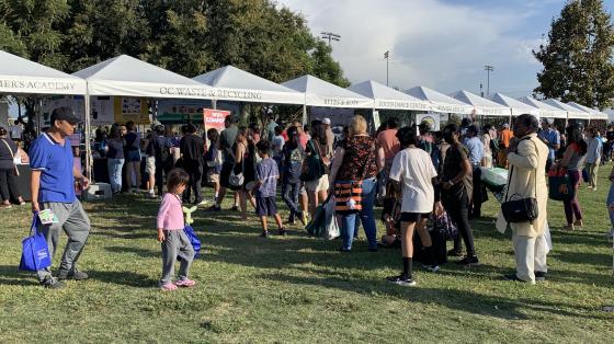 Booths with a crowd of people surrounding