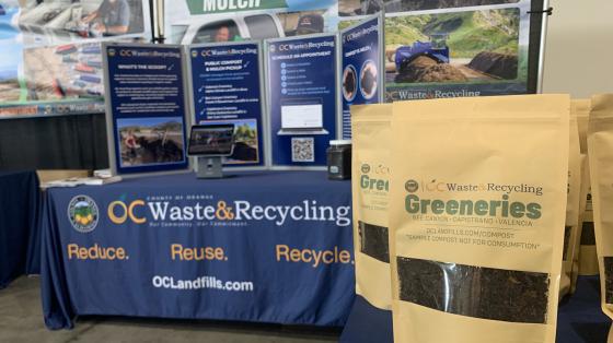 OC Waste & Recycling booth with display and sample compost bags.
