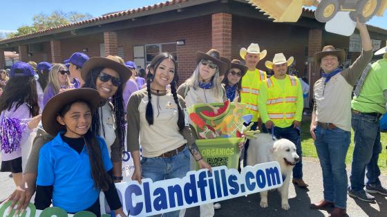 A group of adults dressed in Western gear.