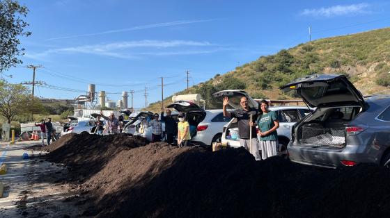 People shoveling compost