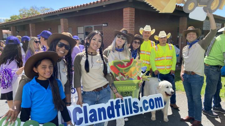 A group of adults dressed in Western gear.