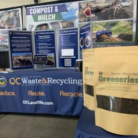 OC Waste & Recycling booth with display and sample compost bags.