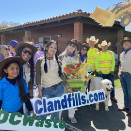 A group of adults dressed in Western gear.