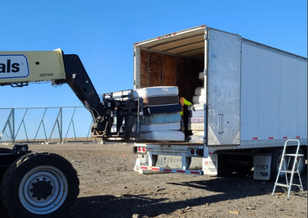 OCWR loading multiple mattresses in the trailer