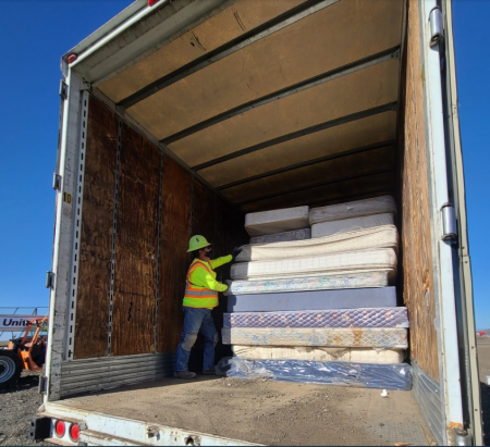 OCWR organizing mattresses in the trailer