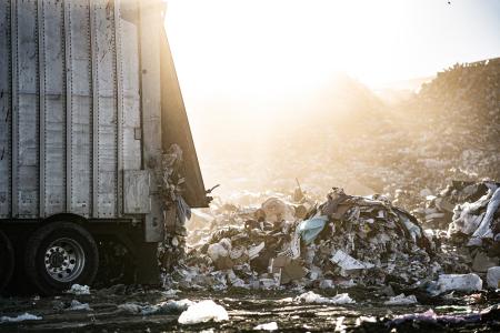 waste hauler unloading trash at the landfill
