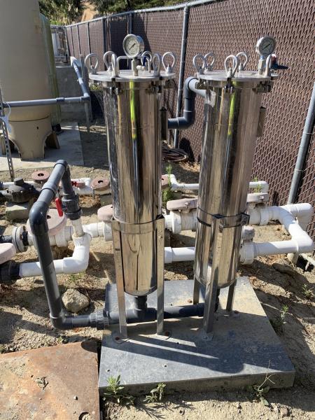 two silver cylindrical canisters are bag filters