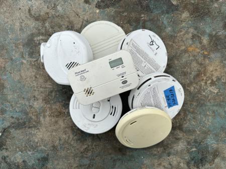Photo of a collection of smoke and carbon monoxide detectors.