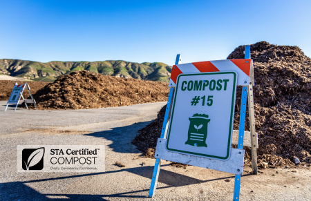 Compost Pile number 15 next to STA certified logo