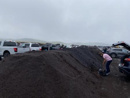 Resident shoveling compost