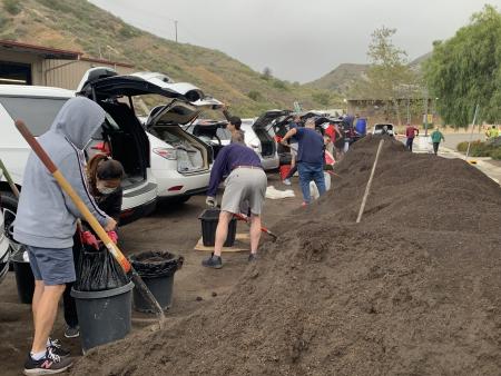 Resident shoveling compost