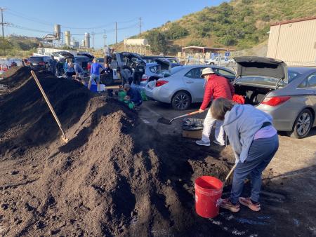 People picking up compost